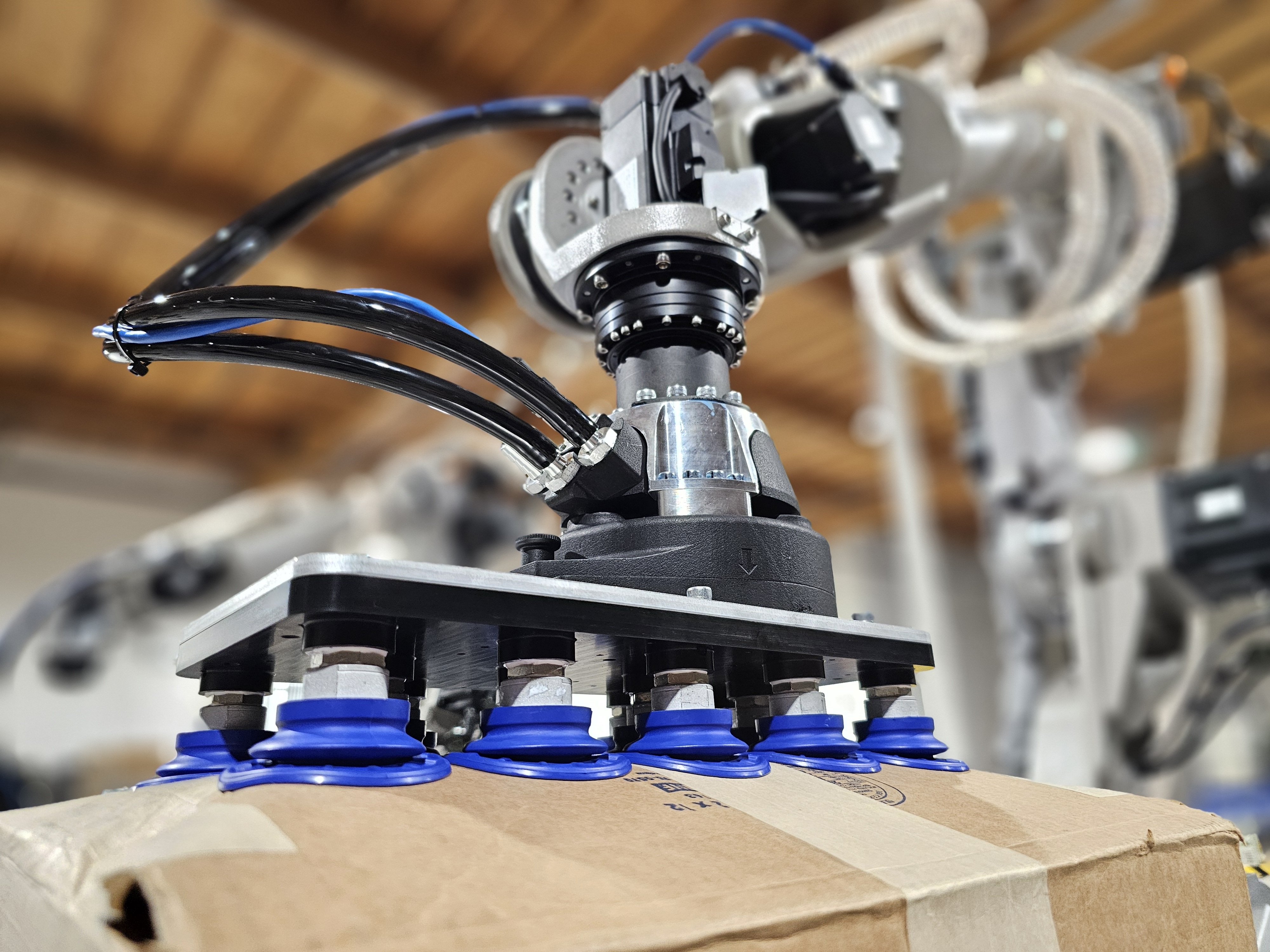 Mech end effector handling a box