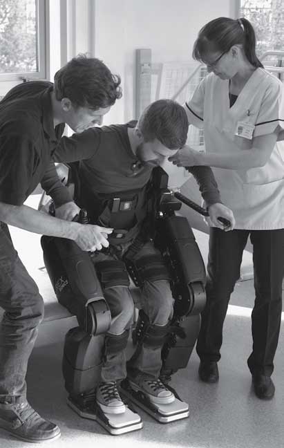Physiotherapists supporting a user in REX