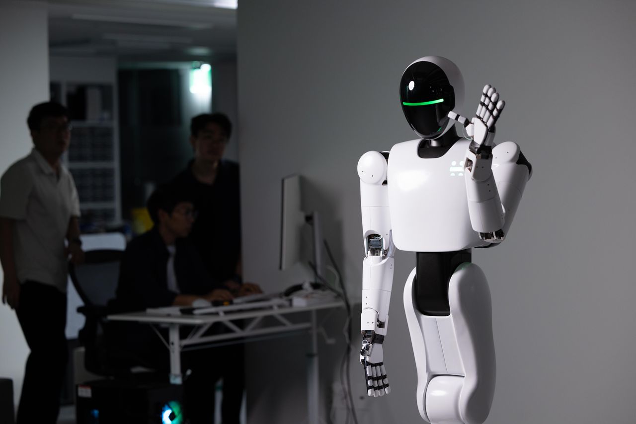 FRIDAY humanoid raising a hand